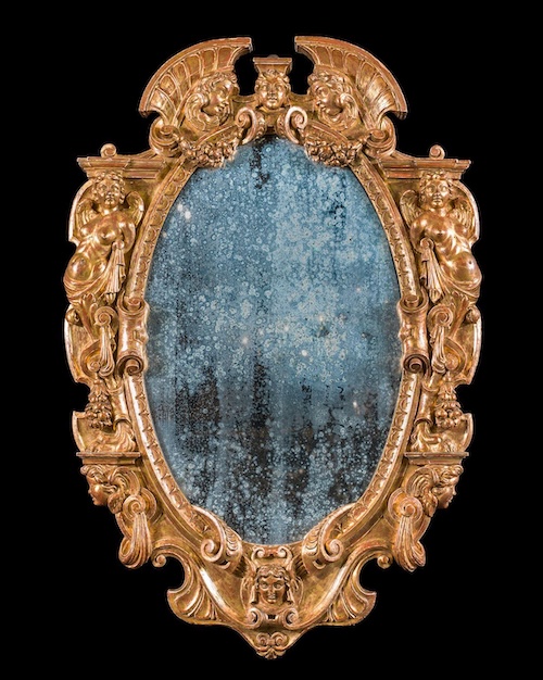 An antique mirror with a gilt frame