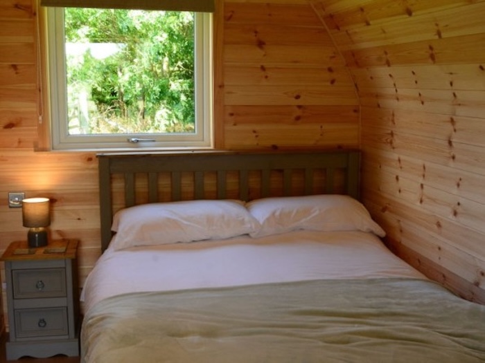The bed area inside a glamping pod