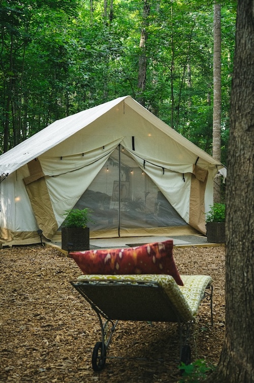 A large Family Camping Tent set up in the woods.