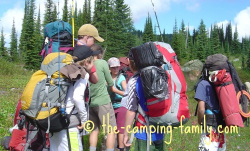 backpackers wearing loaded backpacks