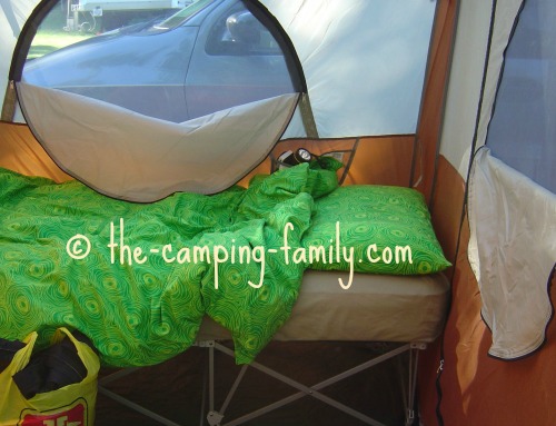 folding camping cot in cabin style tent