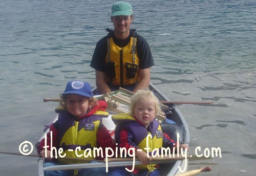 dad and boys in canoe with PFDs