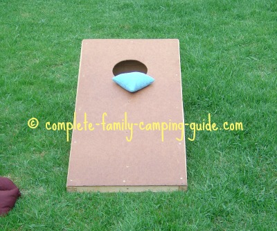cornhole game with bag on board