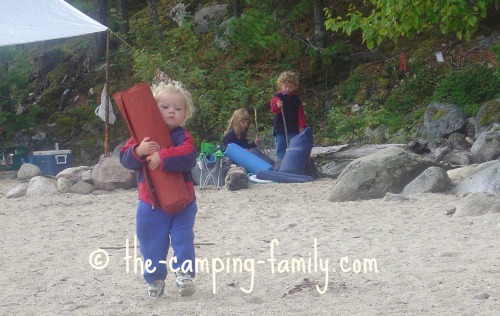 young child carrying Thermarest