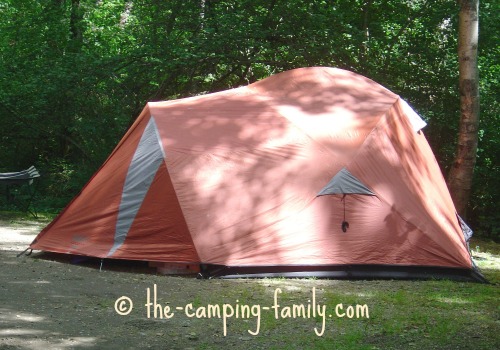 An orange dome camping tent with fly