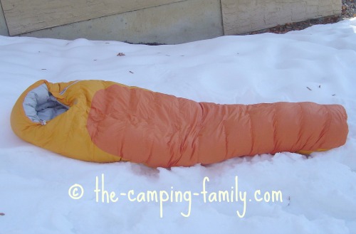 down filled sleeping bag on the snow