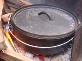 A cast-iron Dutch Oven on a barbeque grill