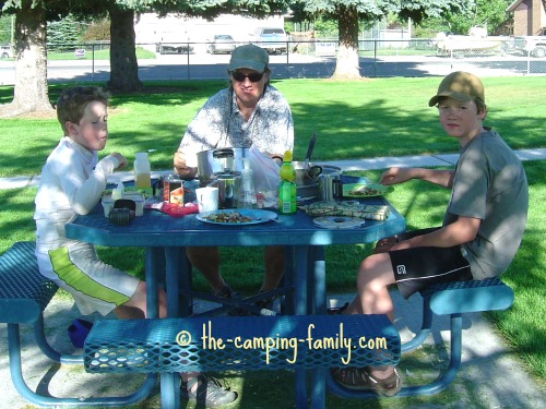 family at picnic table in park
