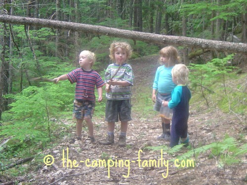 4 small boys in the woods