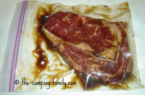 steak marinating in a ziploc bag