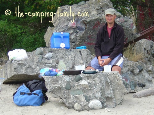 man cooking on the beach