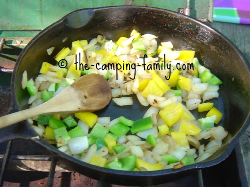 onions and peppers in skillet