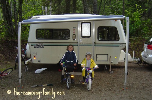 two boys beside Bigfoot trailer