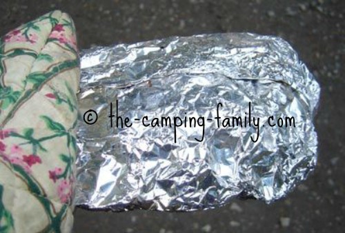 holding foil packet with oven mitt