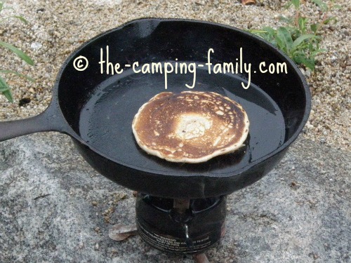 pancake in skillet on backpacking stove