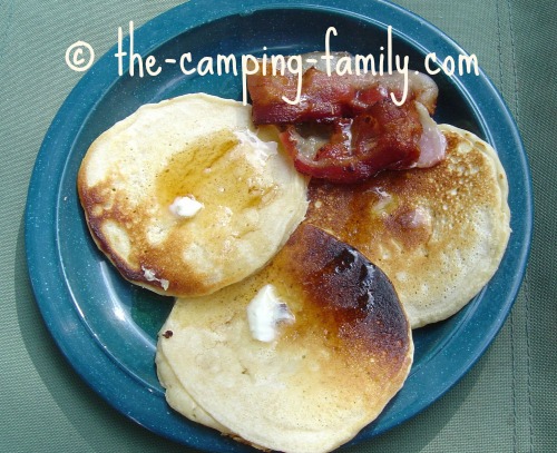 pancakes and bacon on a camping plate