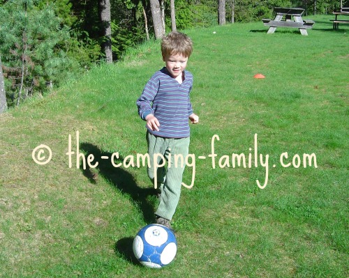 boy kicking a soccer ball