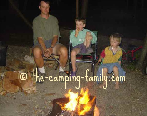 dad and small boys around the campfire