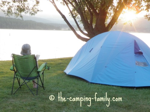 woman sitting on Strongback chair near tent