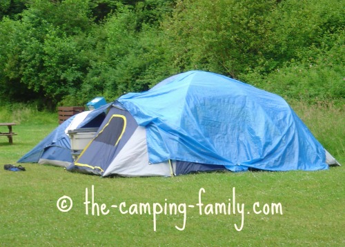 tent draped with blue tarp