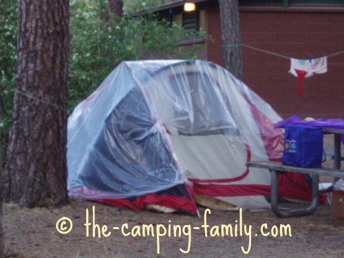 tent draped with clear tarp