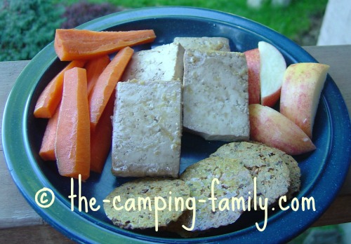 Baked Tofu on plate with veggies and fruit