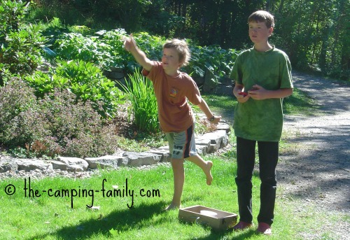 washer toss game on grass