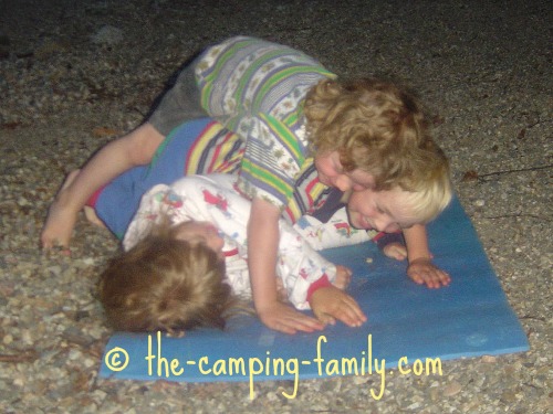 3 little boys wrestling on foam pad