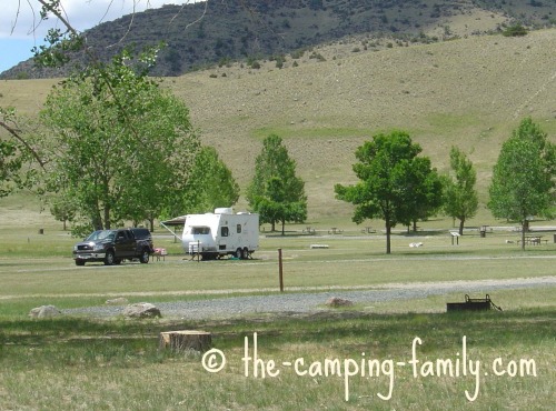 truck and trailer in grassy campground