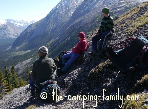 backpacking family resting in the mountains
