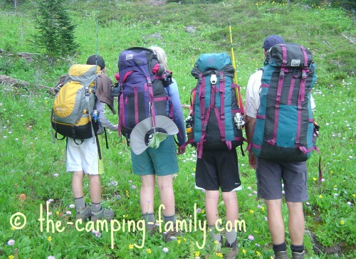 4 hikers wearing backpacks