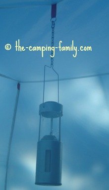 candle lantern hanging in a tent