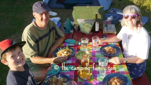 camping family at picnic table