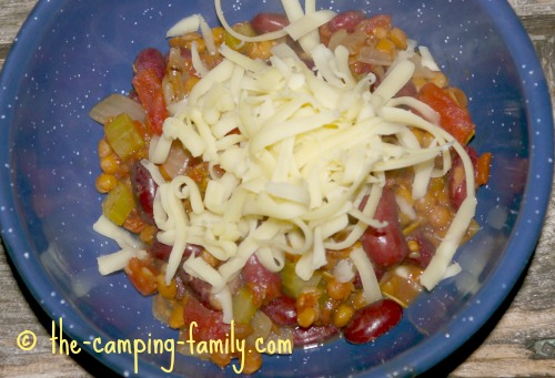 Lentil Skillet Supper in bowl with grated cheese