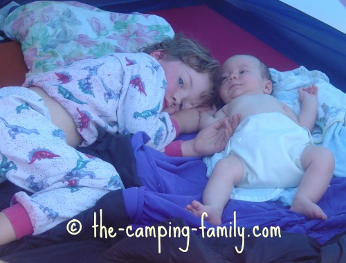 little boy and baby in tent