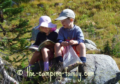 two children reading on the trail