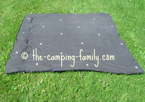 rectangular sleeping bag open on grass