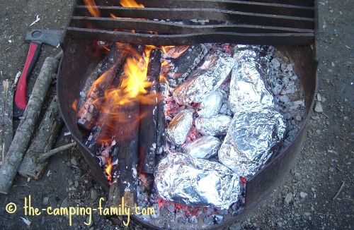 campfire with tinfoil dinners in coals