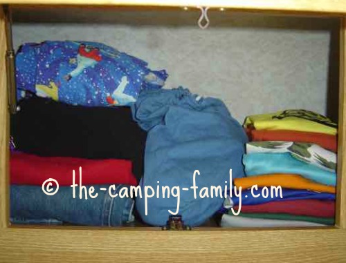 small cloth bag in RV cupboard with clothing