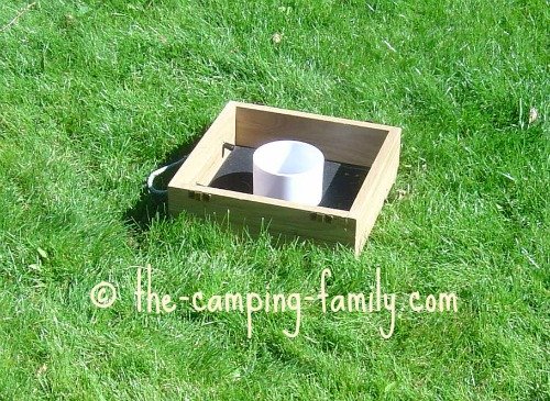 washer toss game on grass